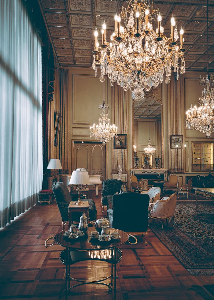 why-choose-us Elegant hotel lobby with vintage decor and grand chandeliers.